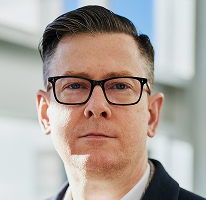 Dirigente Alexander Hughes, CEO di un'azienda di trading crypto, ritratto.